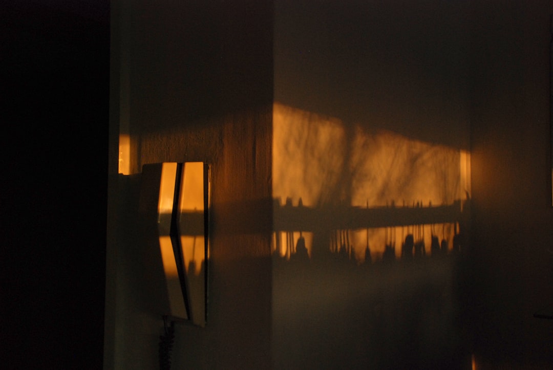 Interior shot of a room in an abandoned building, with peeling paint and visible water damage on the walls, highlighted by...