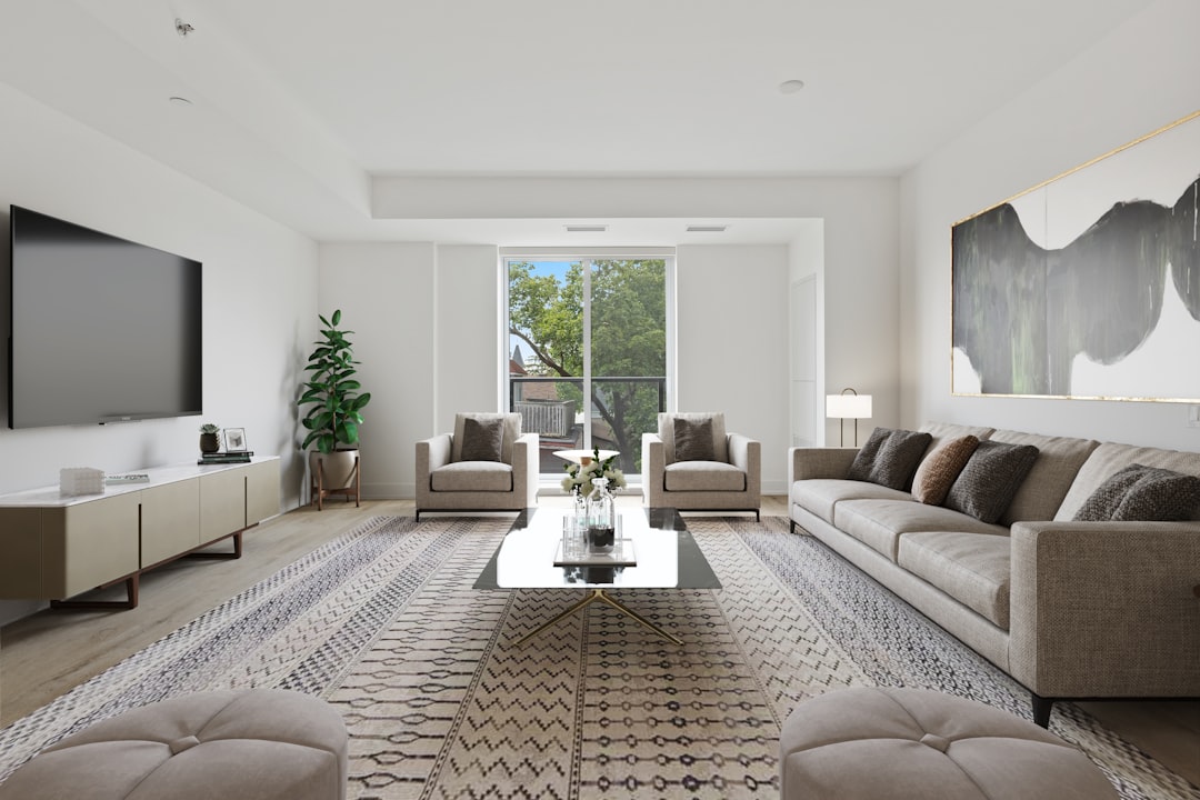 Beautifully staged modern living room with a neutral color palette, flooded with natural light, showcasing a prime example...